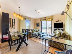 a living room with a table and a couch at Belvilla by OYO Holiday home in Jand a in Morro del Jable