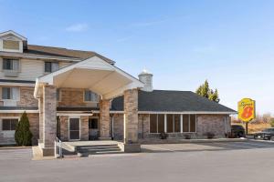 a building with an awning in a parking lot at Super 8 by Wyndham Joliet I-55 N/Chicago in Joliet