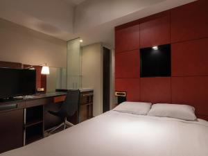 Säng eller sängar i ett rum på Hotel Vista Sapporo Nakajima Koen