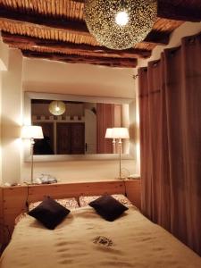 une chambre avec un lit et un grand miroir dans l'établissement Dar Farah, riad au coeur de la médina, à Essaouira 27 autres photos
