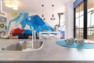 a kitchen counter with a sink and a living room at NEVERENDING RIJANA. ¡Cala Rijana a tu alcance! in Calahonda