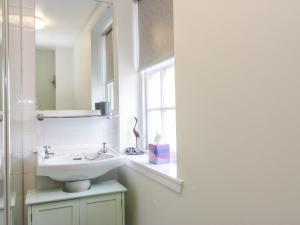 baño blanco con lavabo y ventana en The Toll House, en Melrose 16 fotos más