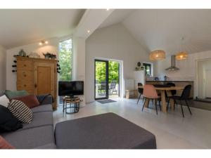 a living room with a couch and a table at Tranquil holiday home in Dishoek with garden in Dishoek