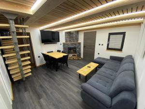 a living room with a couch and a table at Brunarica Chalet Rogla Sauna in Vitanje