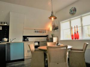 a kitchen with a table and chairs in a room at Apartment in Giethoorn by Scenic Canals in Giethoorn