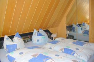 a bedroom with a bed with blue and white pillows at Holiday home in Saxony with private terrace in Schlettau