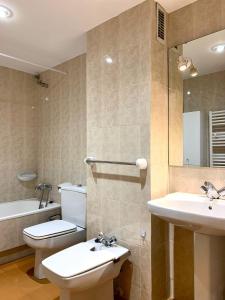 a bathroom with a toilet and a sink and a tub at Apartamento Centrico con Parking in Rialp
