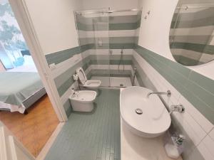 a bathroom with a sink and a toilet and a mirror at Casa L'Agave in Capri +20 photos