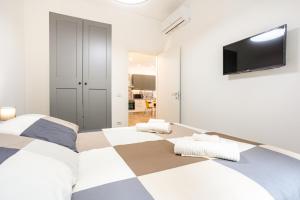 a bedroom with a large bed and a flat screen tv at Vomero Deluxe Apartments in Naples