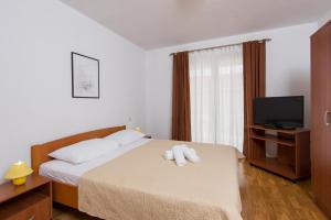 Posteľ alebo postele v izbe v ubytovaní Apartments Darjan