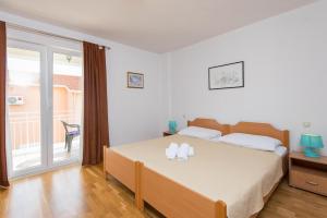 Posteľ alebo postele v izbe v ubytovaní Apartments Darjan