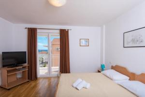 Posteľ alebo postele v izbe v ubytovaní Apartments Darjan