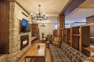 a living room with a couch and a fireplace at Iglika Hotel Borovets in Borovets