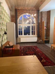 a living room with a couch and a large window at KobyApartment LUX in Herford