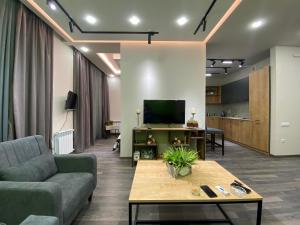 a living room with a couch and a tv at Tsaghkadzor, Kechi House, 1 bedroom Luxury, Modern Penthouse in Tsaghkadzor
