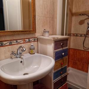 a bathroom with a sink and a mirror and a tub at La casa di Ciaccia in Camaiore