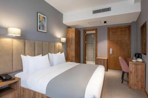 A bed or beds in a room at Barnovi Boutique Hotel