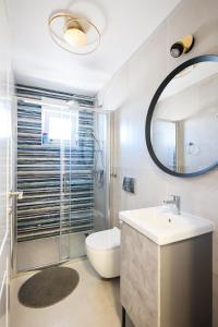 a bathroom with a sink and a toilet and a mirror at Timm apartment in Vir +15 photos