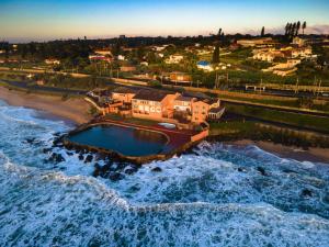 an aerial view of a beach with the ocean at Umkomaas Lodge in Umkomaas