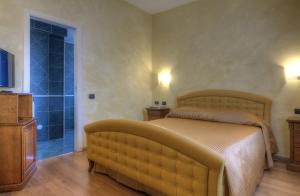 a bedroom with a large bed and a sliding glass door at Central Park Hotel Modena in Modena