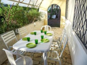 a white table and chairs on a patio at Holiday Home Dominique by Interhome in Lacanau-Océan