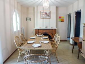 a dining room with a table and chairs and a fireplace at Holiday Home Dominique by Interhome in Lacanau-Océan