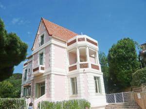 a large white building with a red roof at Apartment Castel Haussmann-1 by Interhome in Cavalaire-sur-Mer