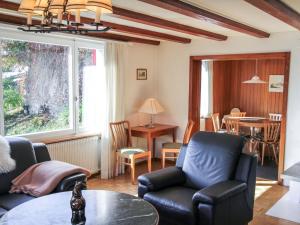 a living room with a couch and chairs and a table at Apartment Chalet Shangri La by Interhome in Grindelwald