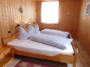 a bedroom with a bed with pillows on it at Holiday Home Aurora by Interhome in Kurort Steinbach-Hallenberg