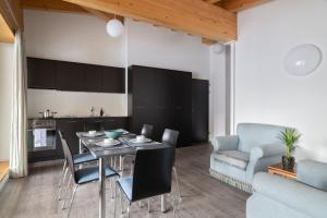 a kitchen and living room with a table and chairs at Townhouse N26 in St. Moritz
