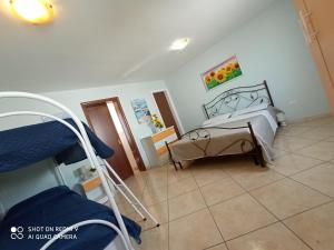 a hospital room with a bed and a couch at Residence Poseidon in Lido Marini
