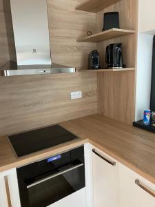 a kitchen with a wooden counter top with a black oven at Chata Večernica in Liptovský Mikuláš