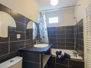 a bathroom with a sink and a bath tub at Apartment Porto di Mar-5 by Interhome in Cavalaire-sur-Mer +18 photos