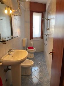 a bathroom with a sink and a toilet at Condominio Canaima in Bibione +13 photos