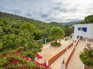 an external view of a villa with a garden at Holiday Home Anromi by Interhome in Cala Vadella