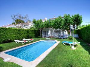 a swimming pool in the yard of a house at Holiday Home Montalt VI by Interhome in Miami Platja