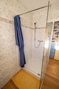a shower with a blue curtain in a bathroom at Coeur-de-charente-maritime, au fil de l'eau in Saint-Germain-de-Marencennes +24 photos