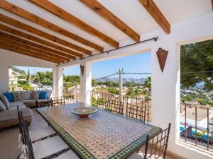 a dining room with a table and chairs on a balcony at Holiday Home El Olivo by Interhome in Moraira
