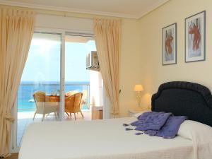 a bedroom with a bed and a view of the ocean at Apartment Sotavento by Interhome in Calpe