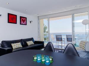 a living room with a black table and a couch at Apartment Brisa al Mar by Interhome in Moraira