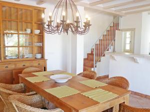 une salle à manger avec une table en bois et un lustre dans l'établissement Holiday Home Eretat by Interhome, à Adsubia