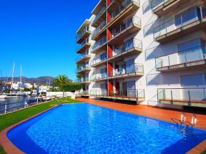 a swimming pool in front of a apartment building at Apartment Cap Mestral by Interhome in Roses