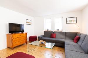 ein Wohnzimmer mit einem Sofa und einem TV in der Unterkunft Ferienhaus Behringen in Behringen