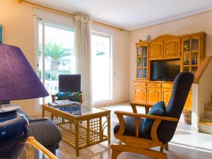 a living room filled with furniture and a tv at Holiday Home Jardines Del Saladar by Interhome in Jávea