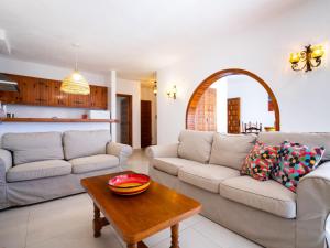 a living room with two couches and a table at Holiday Home Pueblo de la Luz by Interhome in Cumbre del Sol