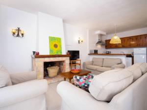 a living room with white furniture and a fireplace at Holiday Home Pueblo de la Luz by Interhome in Cumbre del Sol