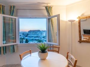 a dining room with a table and a window at Apartment Club Nautic-12 by Interhome in Empuriabrava