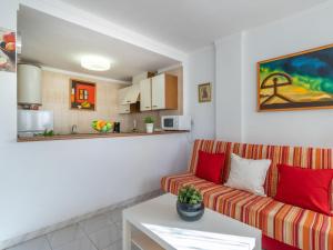 a living room with a couch and a table at Apartment Club Nautic-9 by Interhome in Empuriabrava