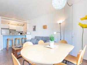 a dining room and living room with a table and chairs at Apartment Gran Reserva-12 by Interhome in Empuriabrava