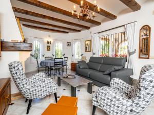 a living room with a couch and chairs and a table at Holiday Home Pinomar by Interhome in Benitachell
